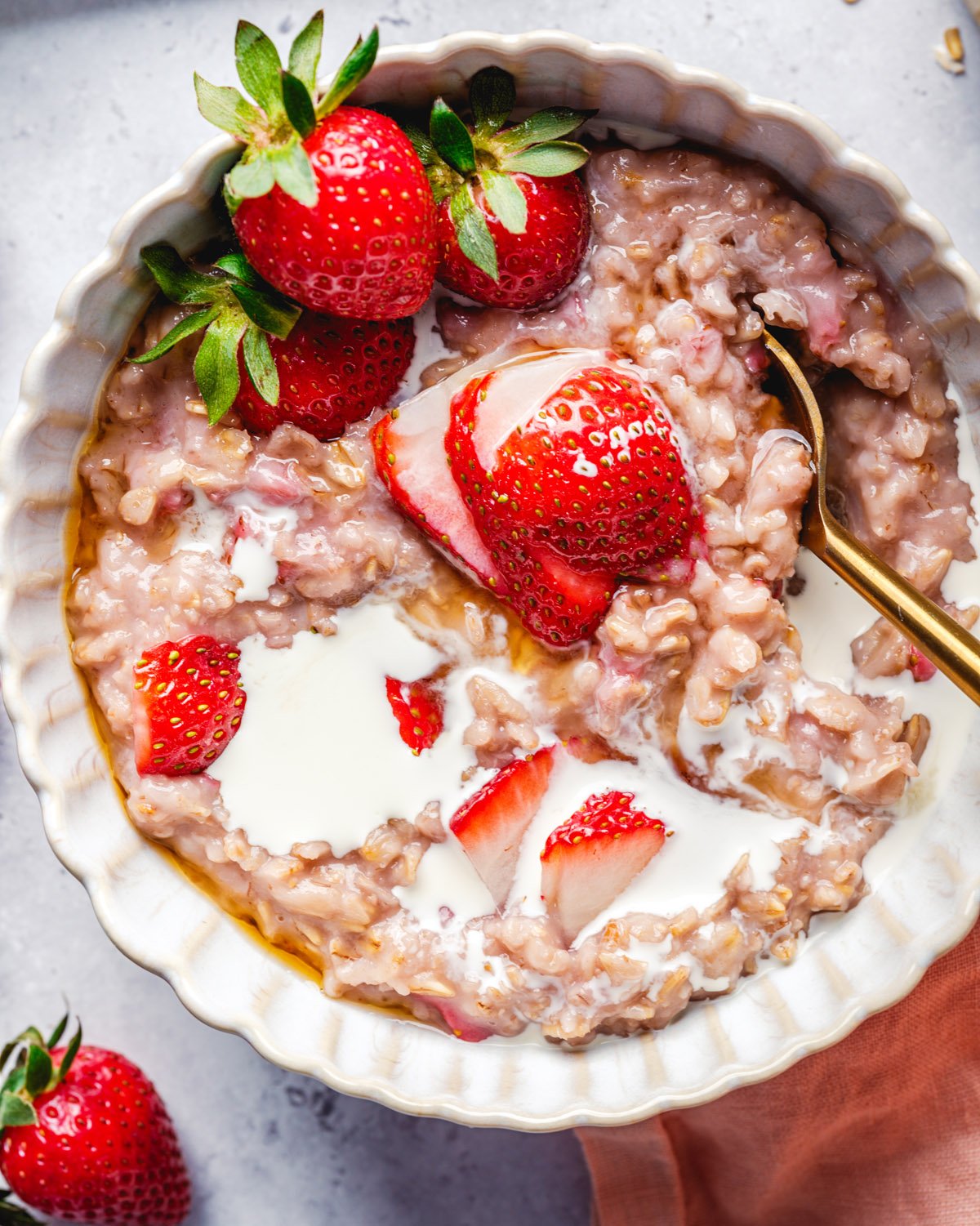 Strawberry Oatmeal in bowl with fresh strawberries.