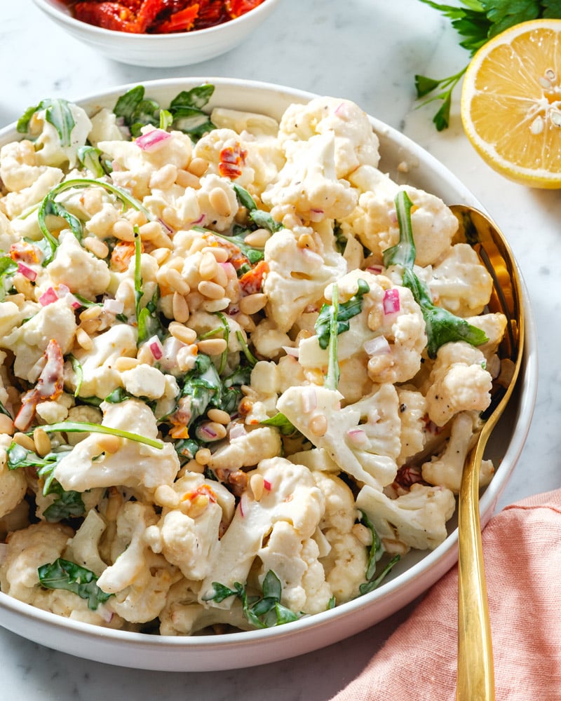 Cauliflower Salad recipe in bowl with spoon.