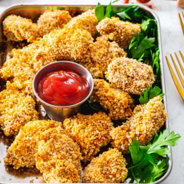Chicken Nuggets on a tray with ketchup.