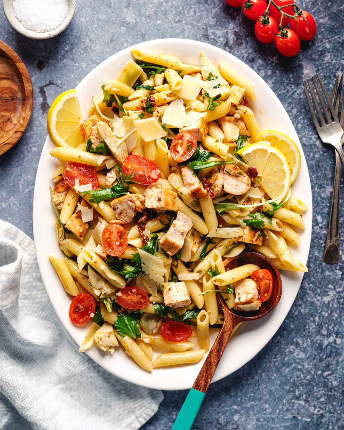Chicken Pasta Salad on plate with lemons and spoon
