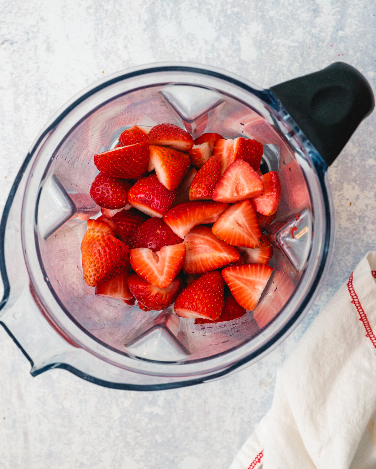 Step 2: Add the strawberries to the blender.
