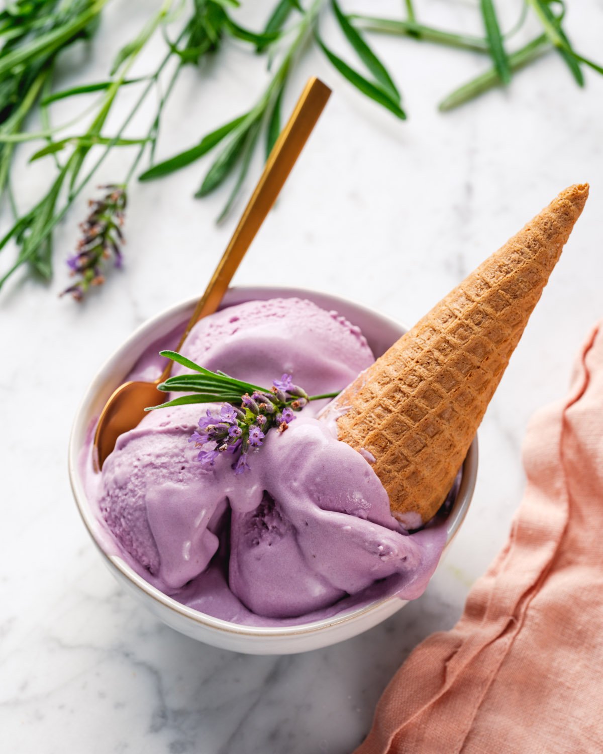 Lavender Ice Cream in cone in bowl.