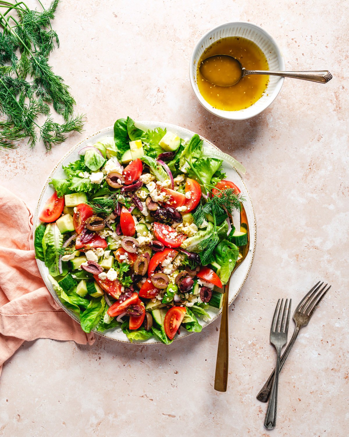 Mediterranean Salad Recipe on plate with vinaigrette dressing.
