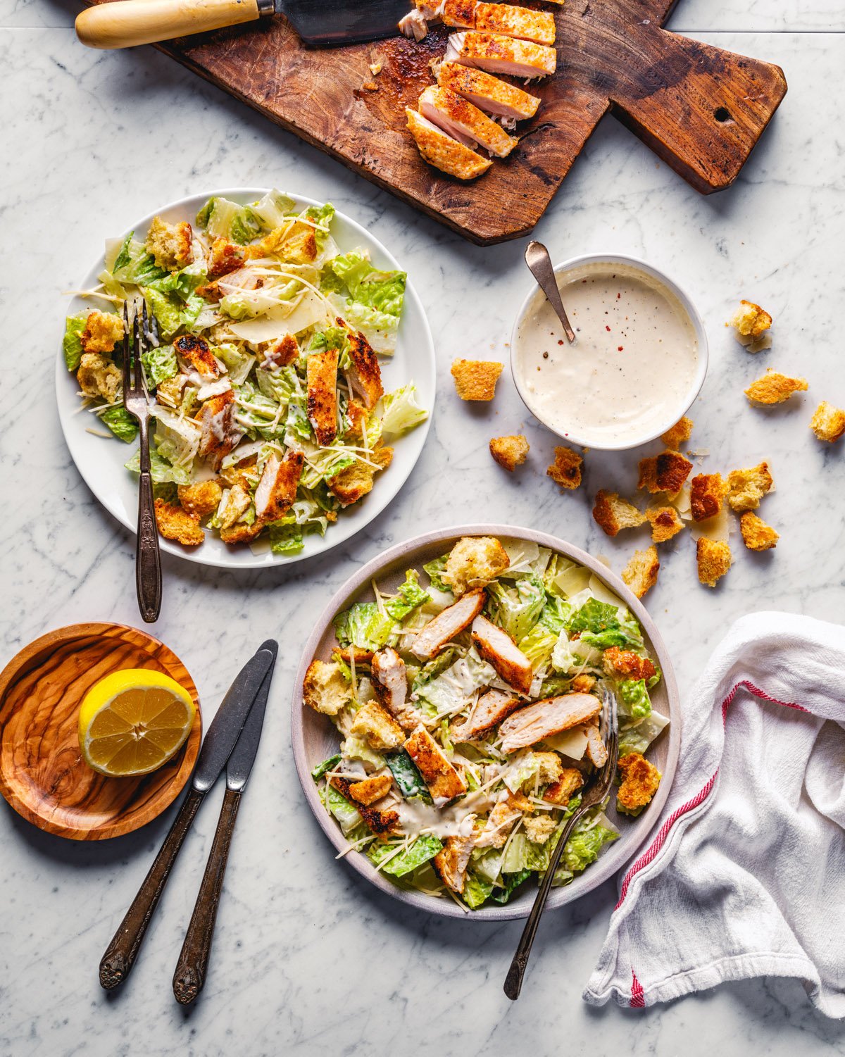 Chicken Caesar salad with dressing and croutons.