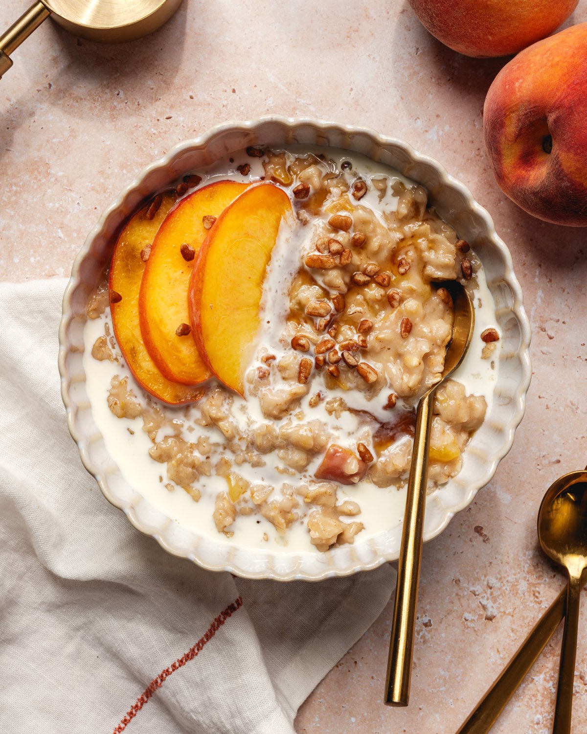 Peach oatmeal with bowl and spoon.