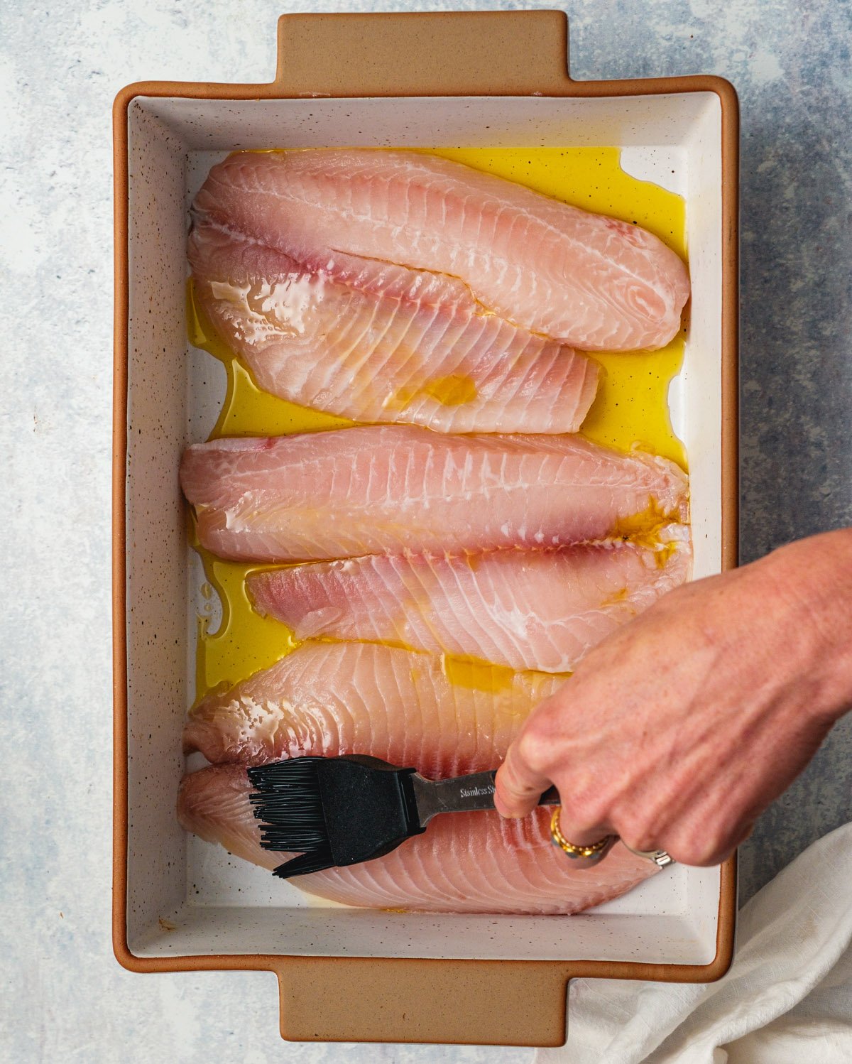 Drizzle the tilapia with olive oil