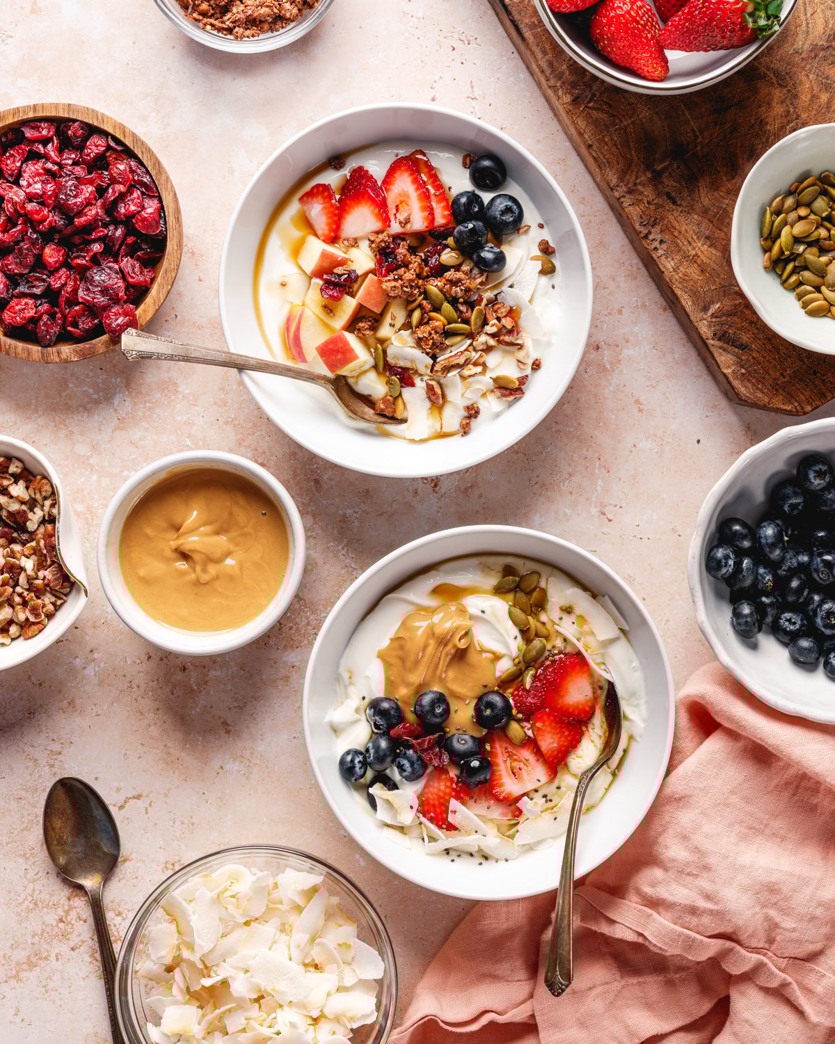 Yogurt Bowl with bowls of fruit, nuts, and seeds toppings