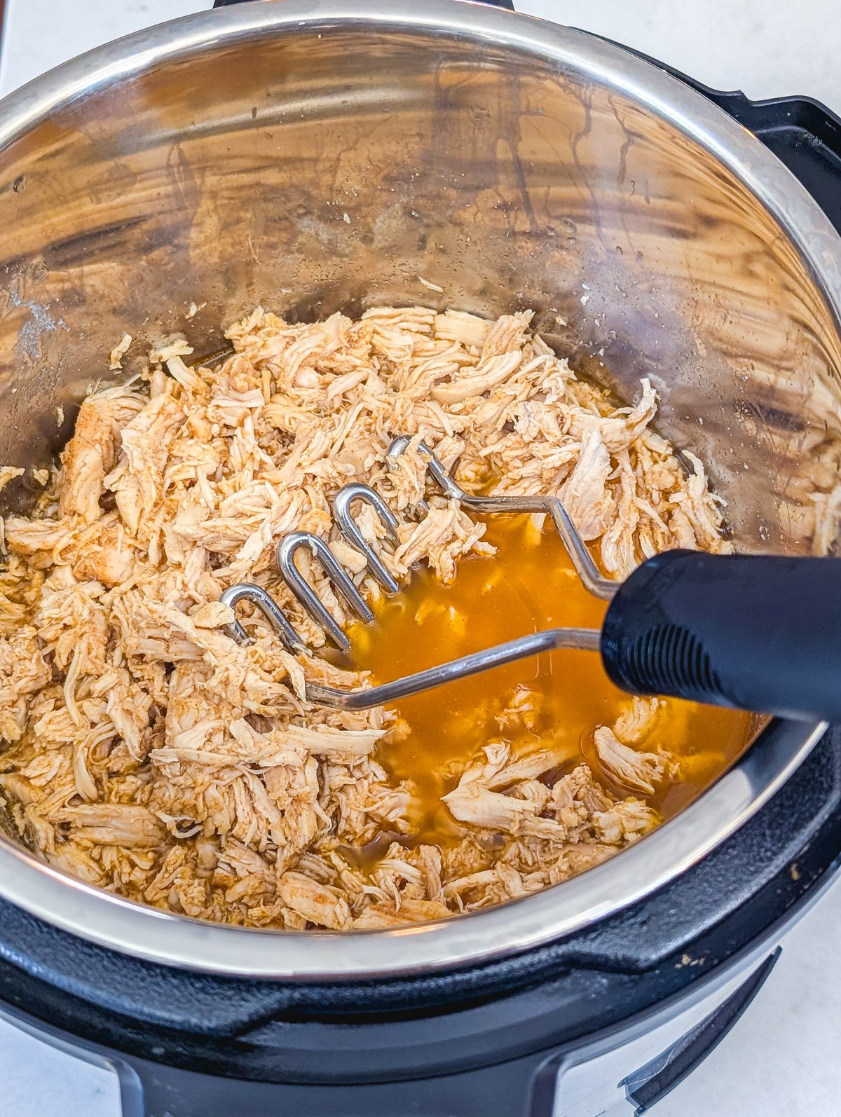 Step 3: Mash or shred the chicken.
