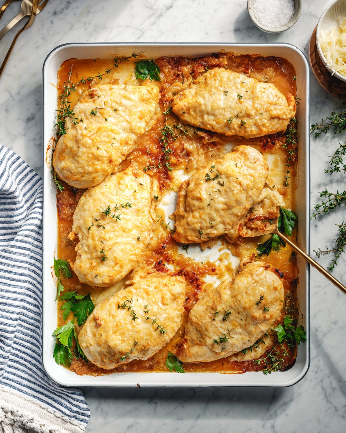 French onion chicken in pan with spoon