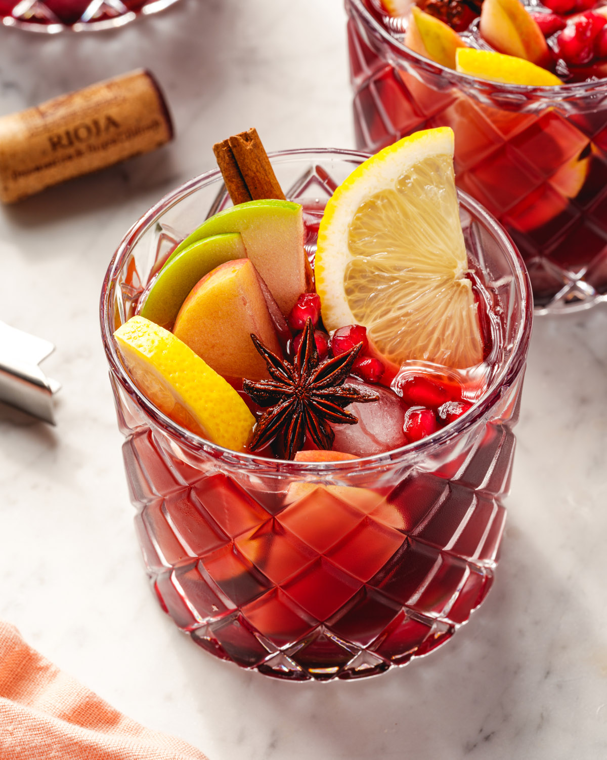 Thanksgiving Sangria in glass with fruit and spice garnish