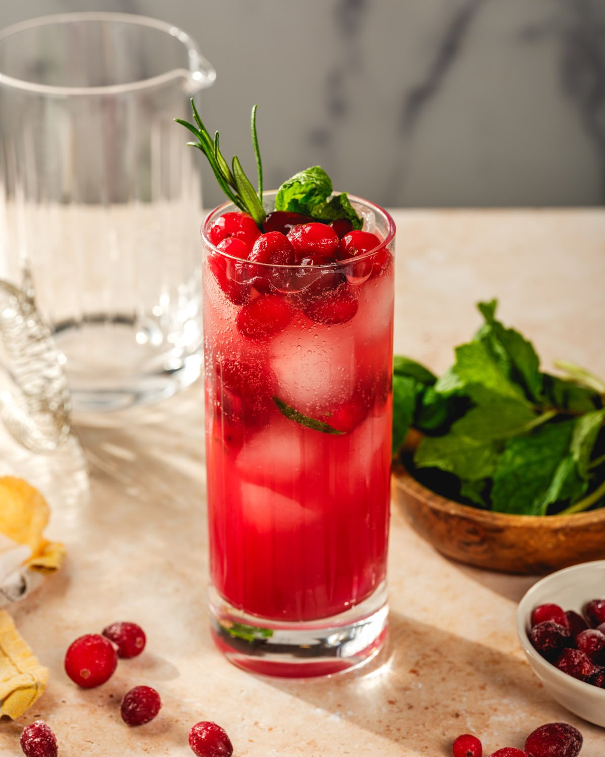 Ginger beer mocktail in collins glass with cranberries