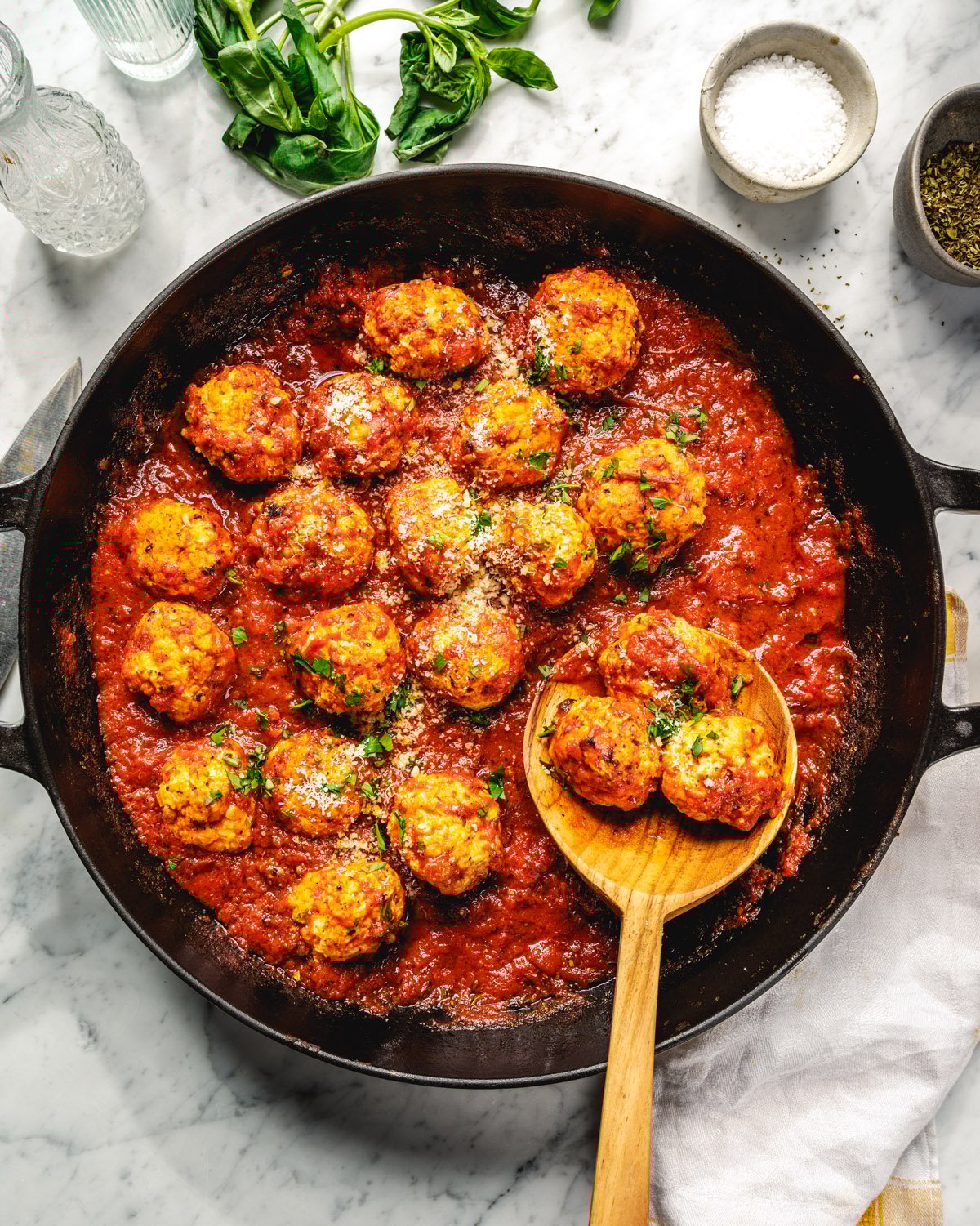 Chicken meatballs in marinara sauce with spoon