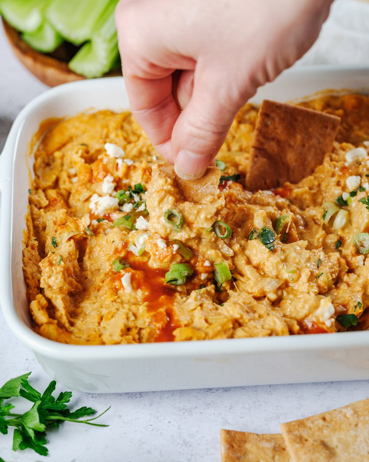 Hand dipping healthy buffalo chicken dip