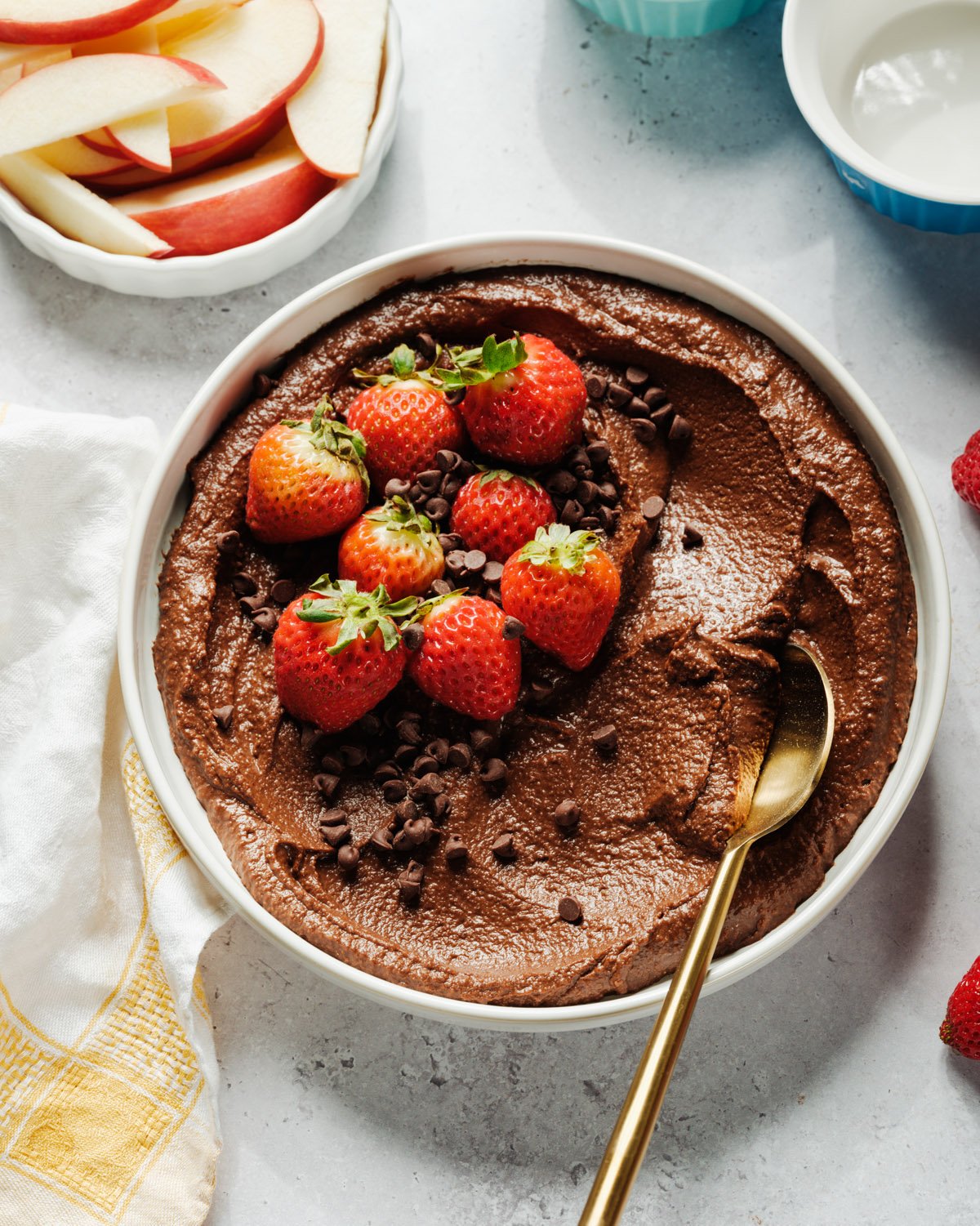 Brownie Batter Hummus in bowl with spoon and strawberries