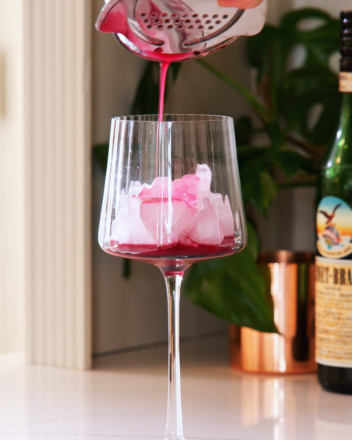 Straining a lemon blueberry mocktail